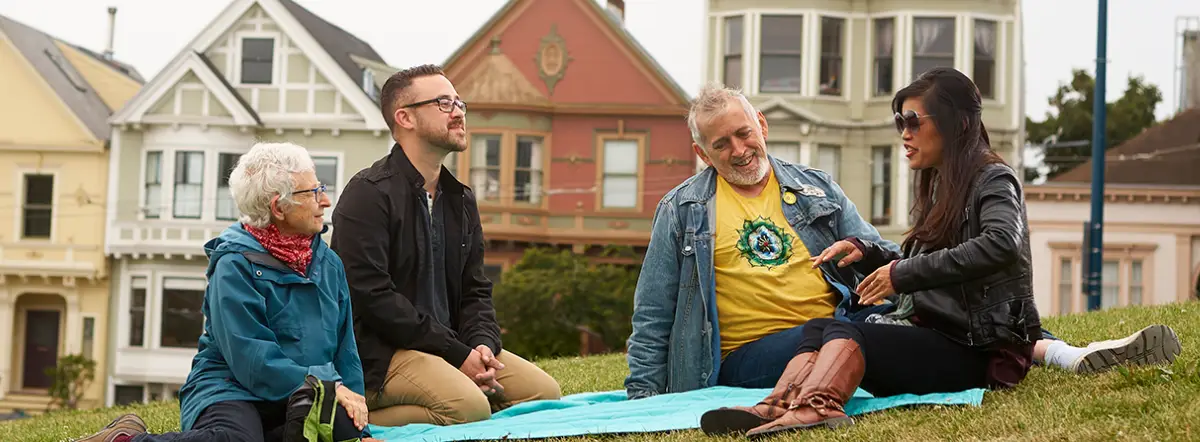 Four people sitting on a blanket outdoors in San Francisco