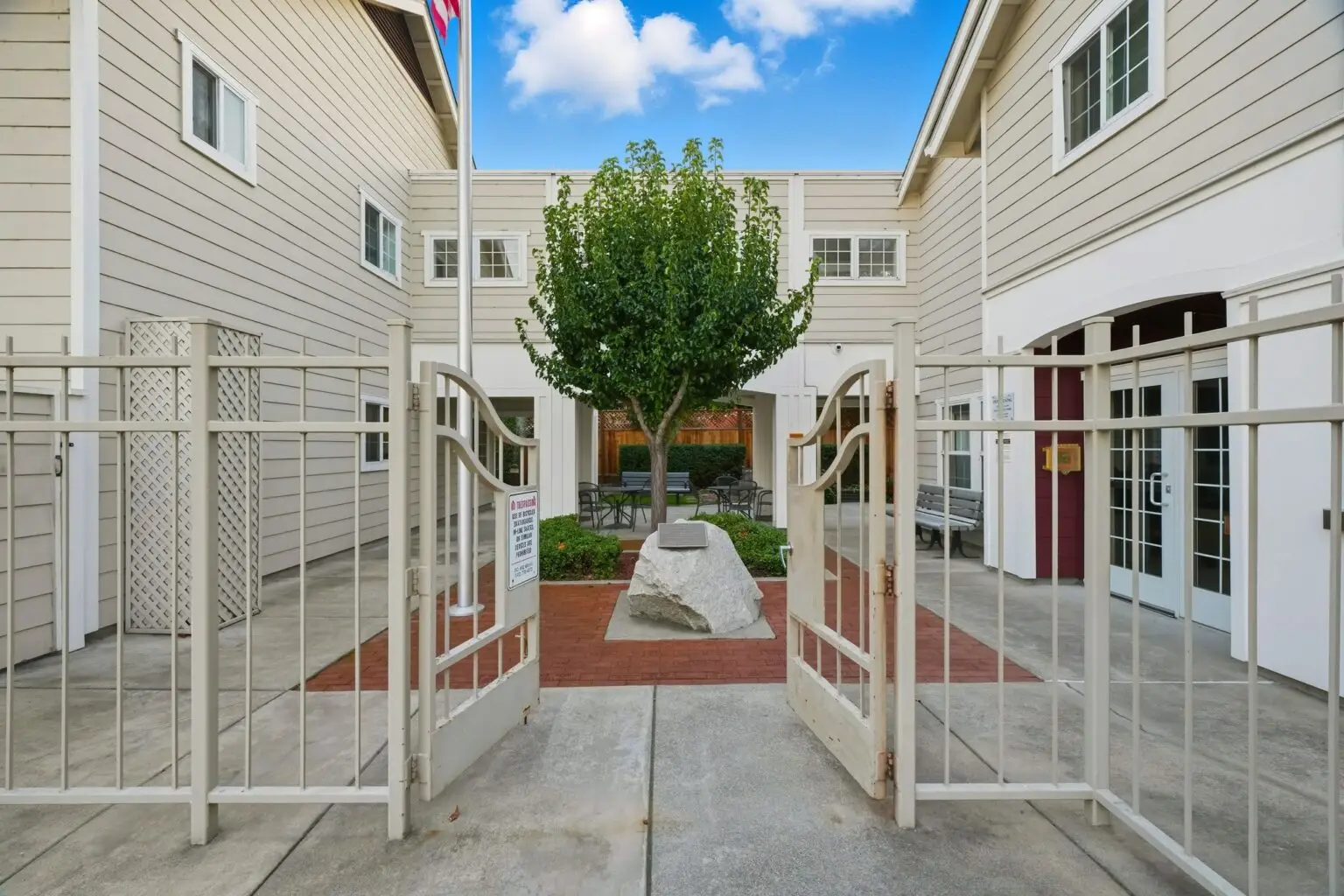 Richard S. Lieb Senior Apartments entry gate with a tree.